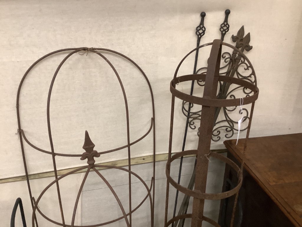 Nine assorted wrought iron growing frames and stakes, largest 148cm high